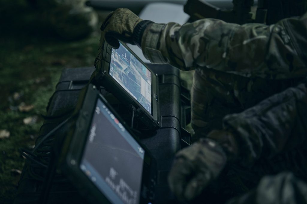 Operator using Sky-Watch Mission Software on a rugged tablet